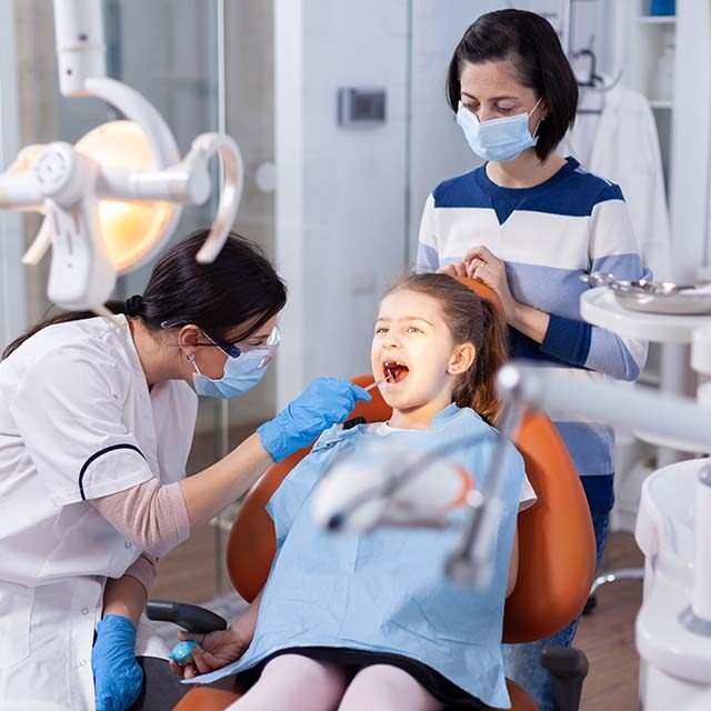 angled-mirror-used-by-dentist-doctor-little-girl-with-mouth-open-dental-office-dentistry-specialist-during-child-cavity-consultation-stomatology-office-using-modern-technology