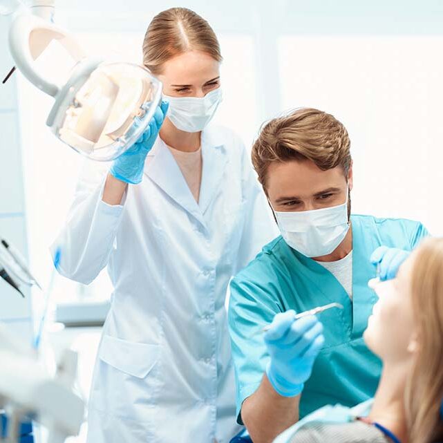 dentist-nurse-treat-patient-dental-office